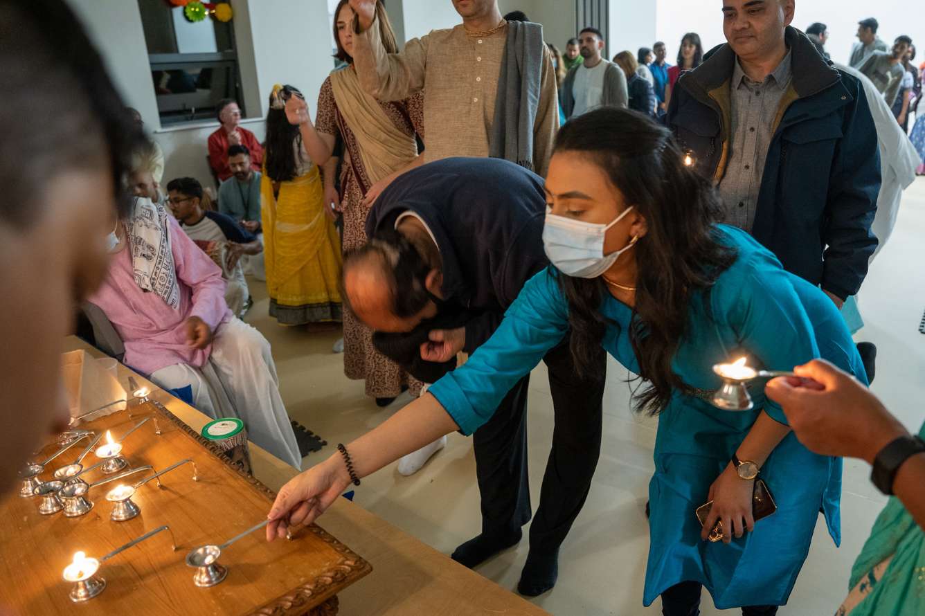 Lighting candles during Go Puja